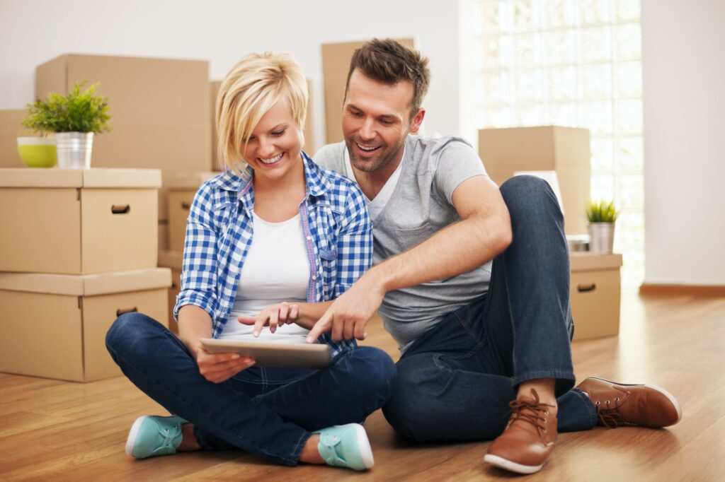 Smiling couple buying new furniture for their home